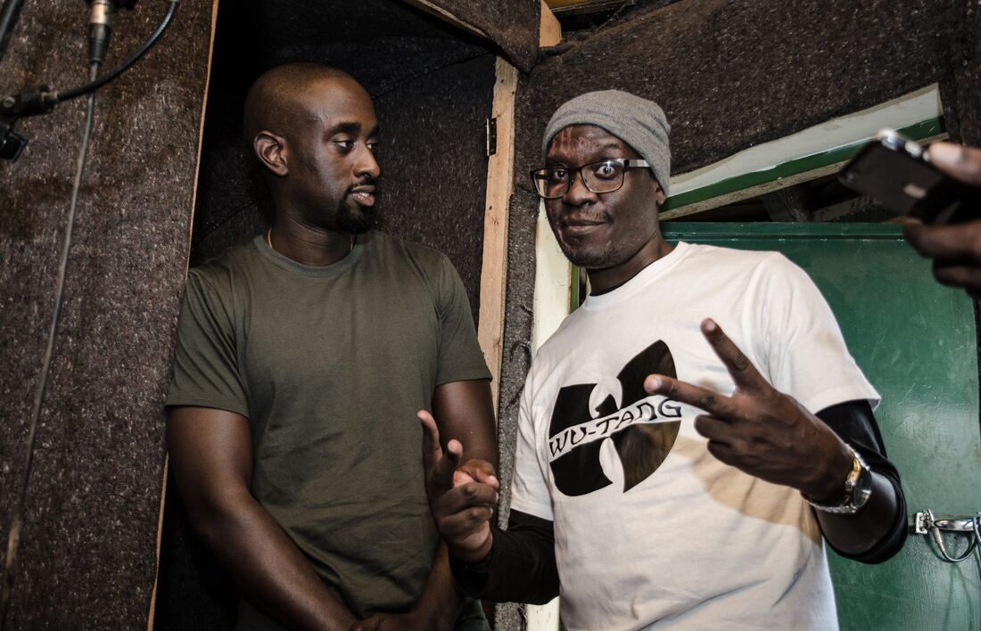 Solodified and a collaborator, fist bump and peace sign, in the studio